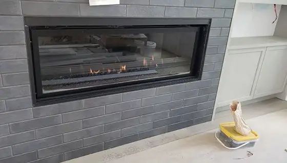 Linear gas fireplace in a tiled feature wall