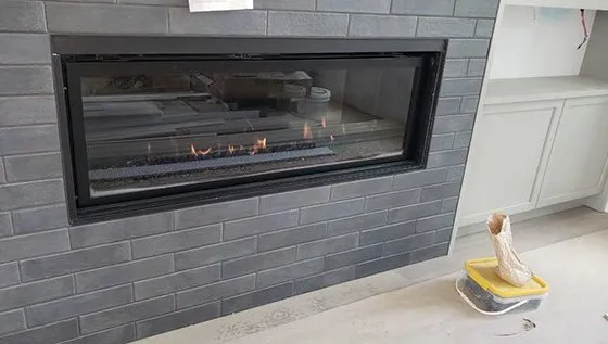 Linear gas fireplace in a tiled feature wall