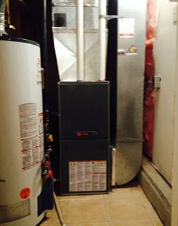 New furnace installed beside a hot water tank